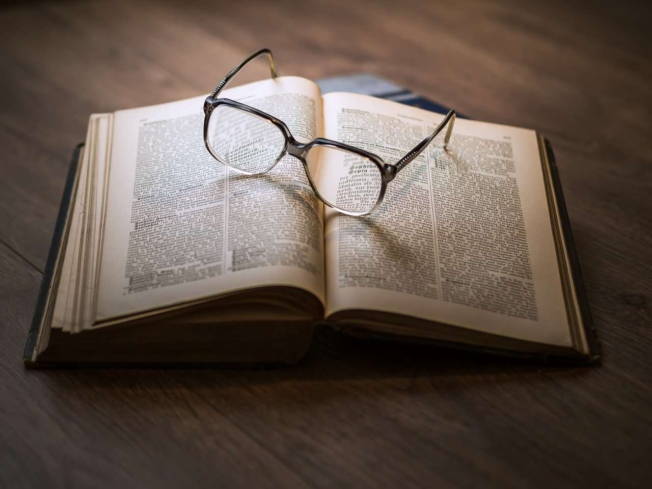 glasses and textbook on business loan terminology