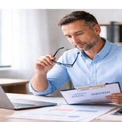 business owner reviewing financial documents while evaluating short-term financing decisions and cash flow impact