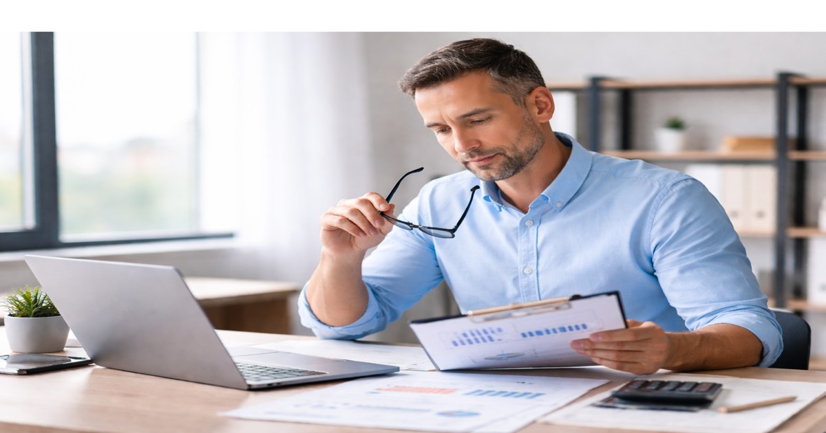 business owner reviewing financial documents while evaluating short-term financing decisions and cash flow impact
