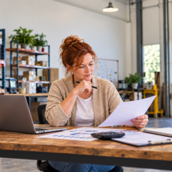 Business owner reviewing borrowing base line of credit documents in a warehouse office