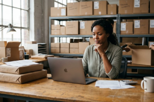 Business owner reviewing finances while strong sales create poor cash flow